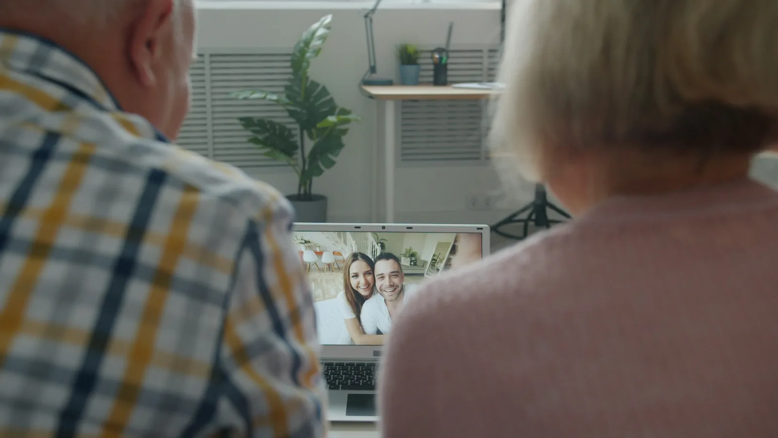 An older couple on a video call at home
